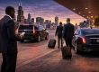 Multiple executives arriving in Chicago with chauffeur transportation, black luxury sedan and SUV