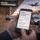 Traveler reviewing airport transportation questions on a smartphone at an airport pickup area in Chicago